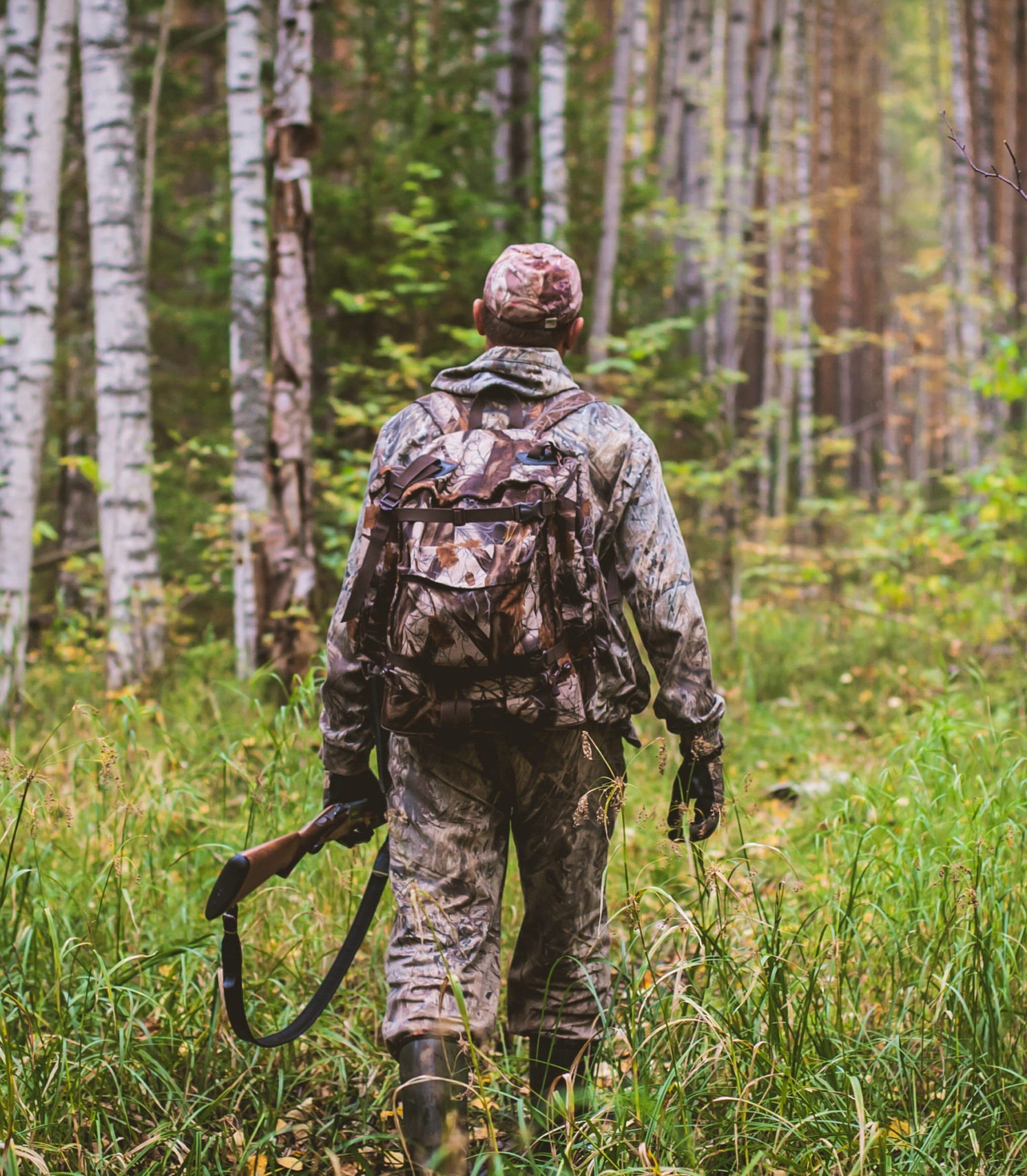 hunter with gun in the forest